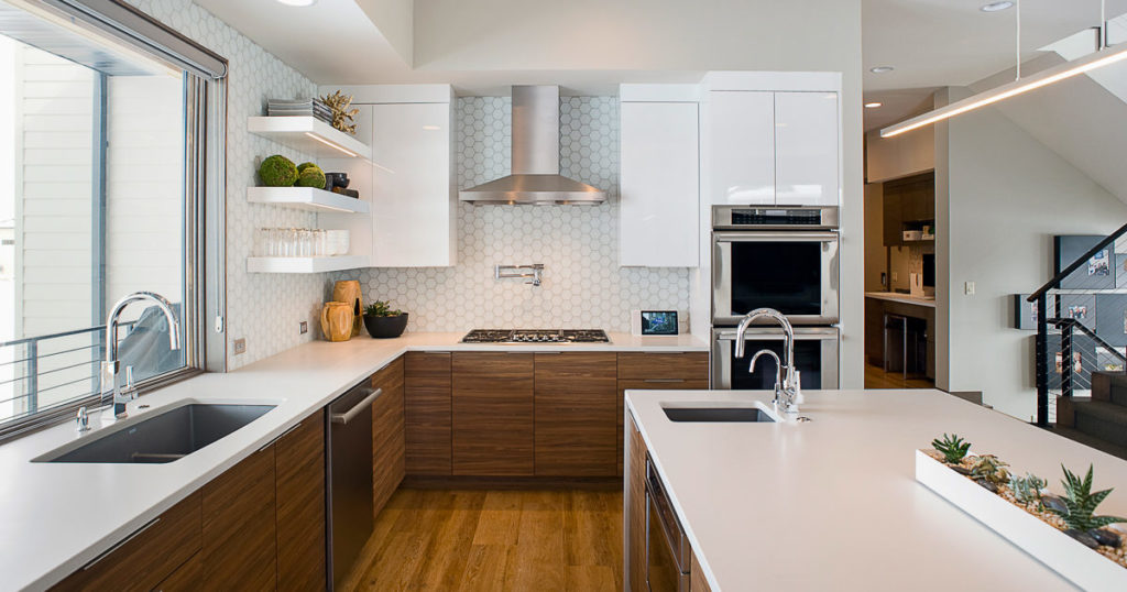 White modern kitchen with quartz countertops and floating shelves