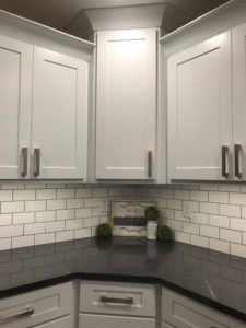 White cabinets with subway tile backsplash and Cambria quartz